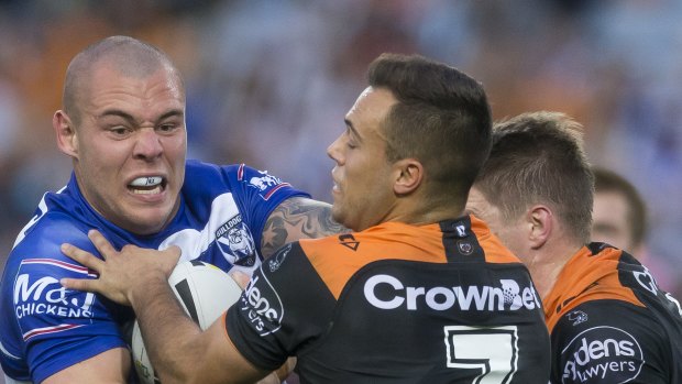 Rampaging: David Klemmer takes the ball forward for the Dogs. 