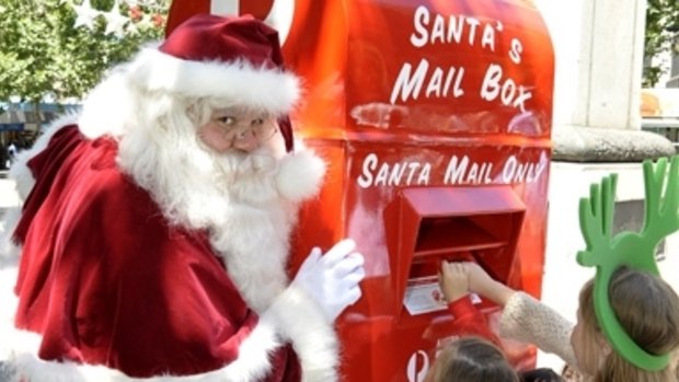 Father Christmas checks the post in the City Square, Swanston Street.