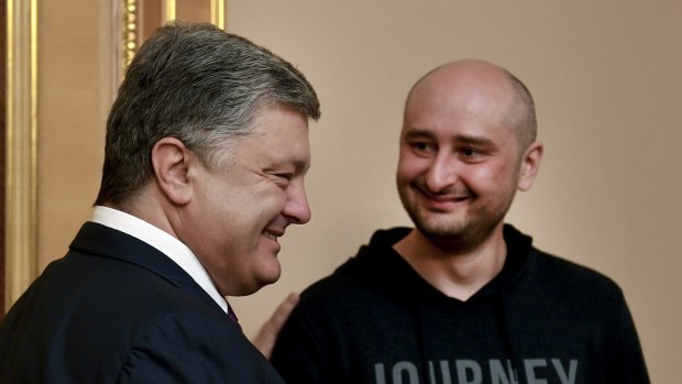 Ukrainian President Petro Poroshenko, left, and Russian journalist Arkady Babchenko meet in Kiev on Wednesday.