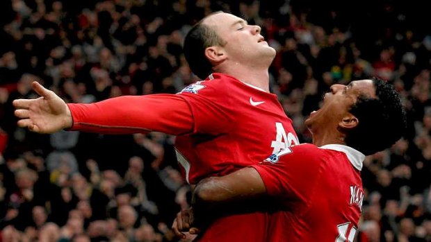 Wayne Rooney of Manchester United celebrates with teammate Nani.