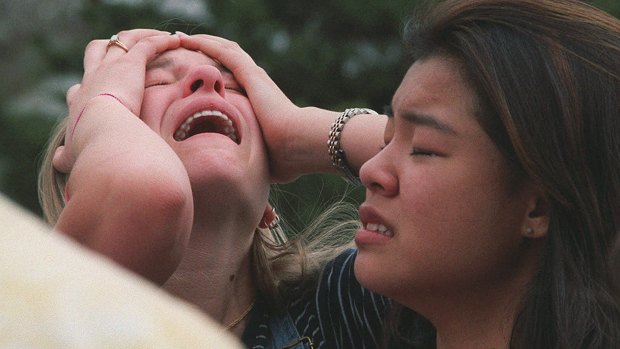 Students react at a triage area near Columbine High School in Littleton Colorado during the shooting rampage by two students in 1999. 