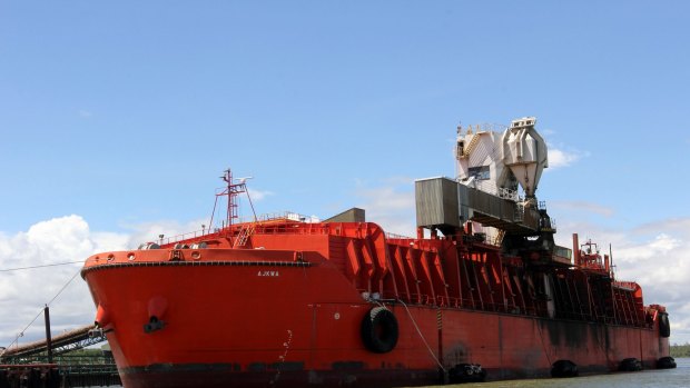 A ship is loaded with copper-gold concentrate from Freeport McMoRan Inc.'s Grasberg copper and gold mine at the company's loading facility in the port of Amamapare, Papua province, Indonesia.