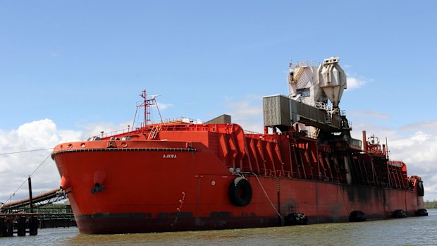 A ship is loaded with copper-gold concentrate from Freeport McMoRan Inc.'s Grasberg copper and gold mine at the company's loading facility in the port of Amamapare, Papua province, Indonesia.