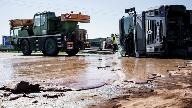 Tons of liquid milk chocolate are spilled and block six lanes on a highway after a truck transporting it overturned near Slupca, in western Poland.
