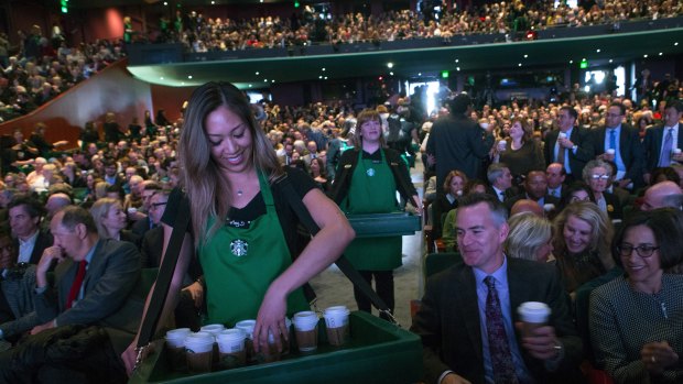 Starbucks employees serve coffee at the annual meeting of shareholders in Seattle in March.