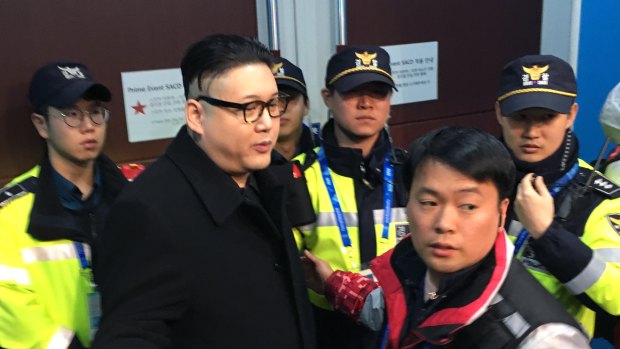 Howard is led away by police officers at the 2018 Winter Olympics in Pyeongchang.