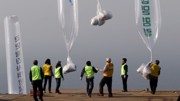 North Korean defectors and South Korean activists release balloons carrying leaflets condemning North Korean leader Kim Jong-il in 2010.