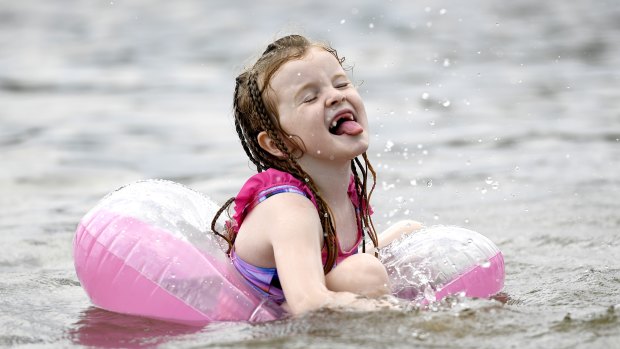 Nora Ward, 6, plays in the water at Mooney's Bay Beach as a heatwave continues in Ottawa.
