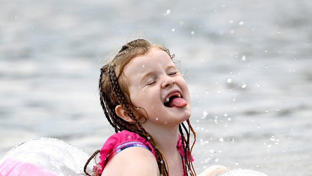 Nora Ward, 6, plays in the water at Mooney's Bay Beach as a heatwave continues in Ottawa.