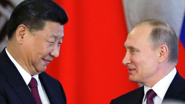 Not the same: Russian President Vladimir Putin, right, and Chinese President Xi Jinping.