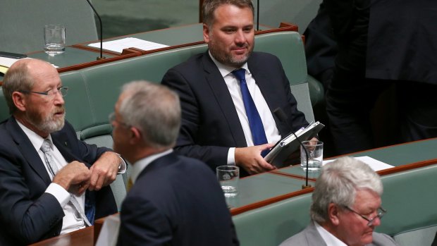 Prime Minister Malcolm Turnbull walks past Jamie Briggs at the end of question time on Tuesday.