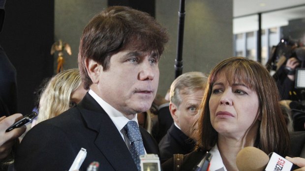 Former Illinois governor Rod Blagojevich, left, speaks to reporters as his wife, Patti, listens at the federal building in Chicago in 2011.