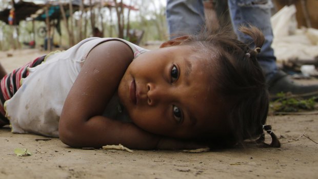 A Venezuelan Yupka girl eyes the camera at a camp set up in Cucuta, Colombia, near the border with Venezuela. Tribe leader Dionisio Finol said they are better off there than in Venezuela, where at least they can eat.