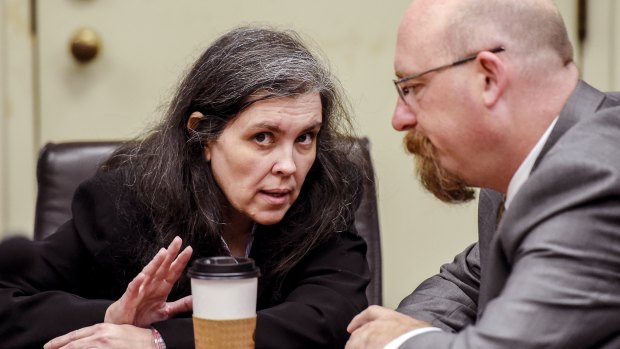 Louise Turpin, left, talks with her attorney Jeff Moore.