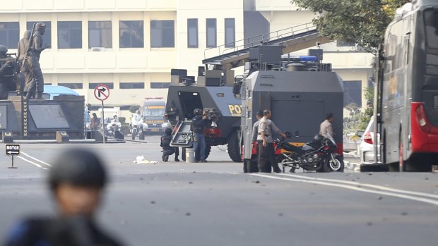 Officers guard the outside of a prison in Depok after prisoners staged a riot. 