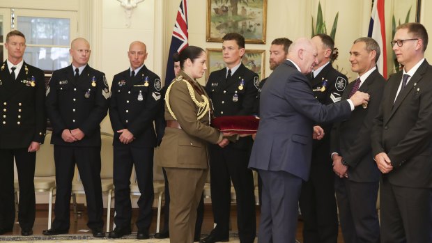 Chief Petty Officer Troy Eather, acting Station Sergeant Robert James, Leading Senior Constable Kelly Boers, Detective Leading Senior Constable Benjamin Cox, First Constable Matthew Fitzgerald, Senior Constable Justin Bateman, Detective Leading Senior Constable Christopher Markcrow, Dr Craig Challen and Dr Richard Harris are presented with the Medal of the Order of Australia (OAM) by Governor-General Sir Peter Cosgrove for their role in the Tham Luang cave rescue operation.