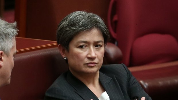 Finance Minister Mathias Cormann and Labor senator Penny Wong in discussion after question time.