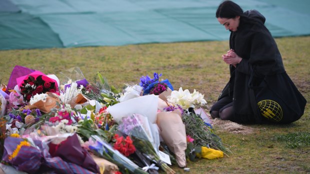 A woman pays her respects at the memorial for Eurydice Dixon in Princes Park.
