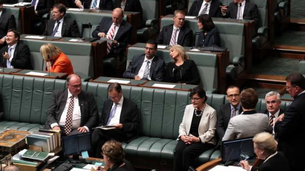 Greens MP Adam Bandt and Independent MPs Andrew Wilkie and Cathy McGowan move to vote with the Government during a division on the debt ceiling. Photo: Alex Ellinghausen