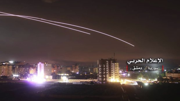 Missiles rise into the sky as Israeli missiles hit air defence position and other military bases, in Damascus, Syria. 