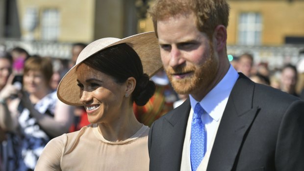 Meghan, the Duchess of Sussex, and her husband, Prince Harry, attend a garden party at Buckingham Palace for Prince Charles 70th birthday last month.
