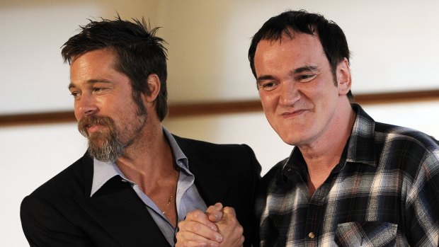 Brad Pitt, left, grabs hands with US film director Quentin Tarantino during a photo call to present their film 'Inglourious Basterds' in 2009