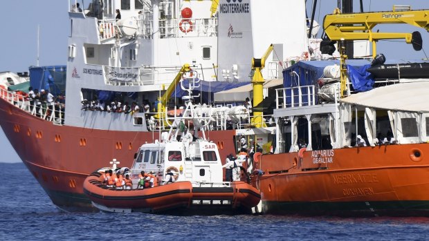 Migrants are transferred from the charity-run Aquarius to Spanish boats on June 12. 