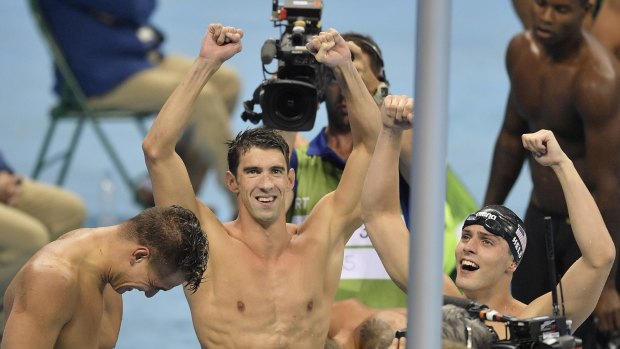 Michael Phelps, centre, celebrates his 19th Olympic gold medal.