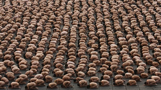 Thousands of naked people crouch in Mexico City's main Zocalo plaza for Spencer Tunick in 2007.