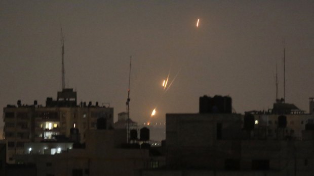 Flames of rockets fired by Palestinian militants are seen over Gaza Strip toward Israeli lands.