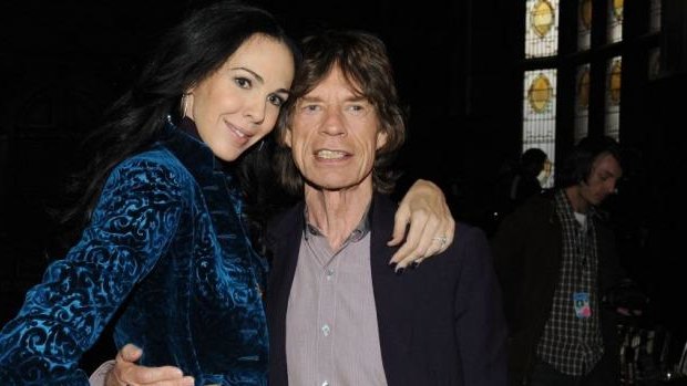 Designer L'Wren Scott and Mick Jagger pose at Fashion Week in New York City in 2012.