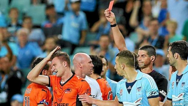 Off you go: Besart Berisha of the Roar receives a red card from referee Peter O'Leary for the tackle on Sydney FC's Seb Ryall.