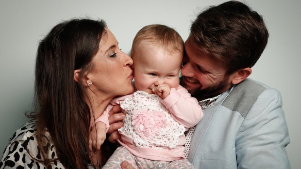 Bethan McElwee and Jonathan McElwee with their 1-year-old daughter Aviana, who has spinal muscular atrophy.