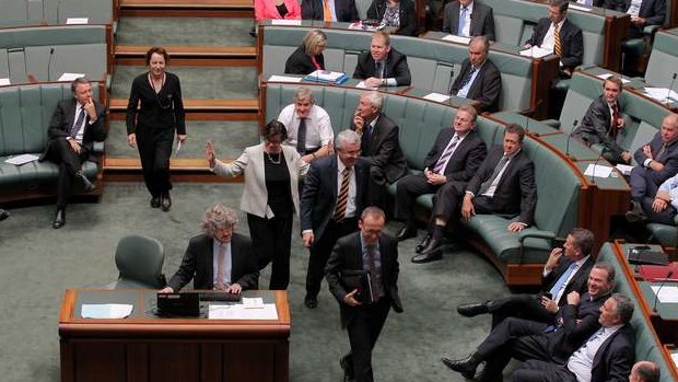 Greens MP Adam Bandt and Independent MPs Andrew Wilkie and Cathy McGowan move to vote with the Government during a division on the debt ceiling. Photo: Alex Ellinghausen