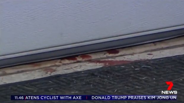 Blood can be seen on the ground outside the garage where the girl was shot. 