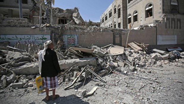 A man looks at damaged buildings after deadly air strikes in and near the presidential compound in Sanaa, Yemen, this month. The war has entered its fourth year.