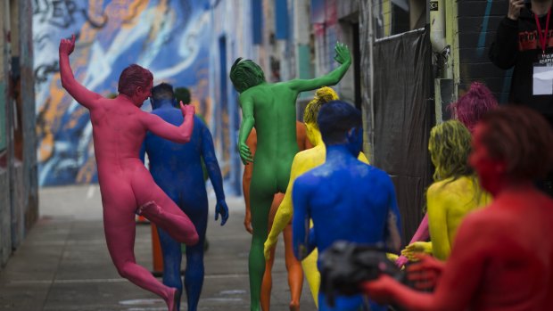 Colour my world: Exhilirated participants in a Spencer Tunick photo shoot - wearing only body paint - strode into Artists Lane in Windsor on Sunday. 