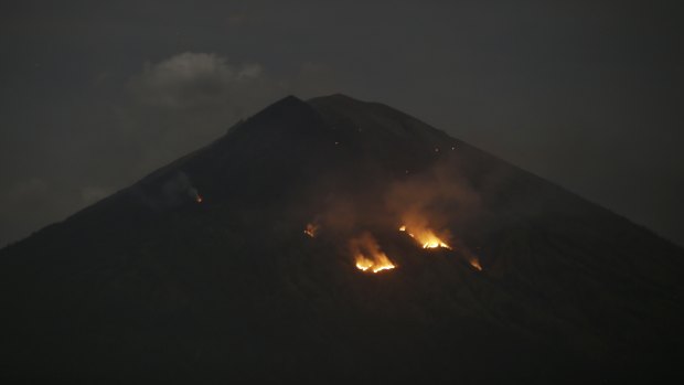 Mount Agung spews smoke in Karangasem, Bali, Indonesia, early Tuesday.