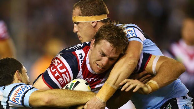Crunched: Roosters utility Mitchell Aubusson is sandwiched by the Cronulla defence.