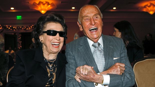 Nancy Sinatra Sr smiles with Paramount Pictures producer AC Lyles, as they attend the unveiling of a giant image of the Frank Sinatra commemorative postal stamp issued on his 92nd birthday in 2007.