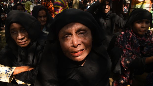 Uma Habi, right, and her sister Murshida Khatun weep as they talk of losing 35 members of their family in the recent violence against Rohingya in Myanmar.