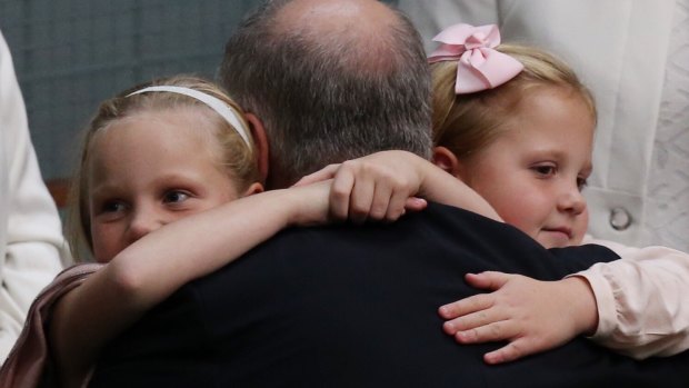 Treasurer Scott Morrison is hugged by his daughters, Lily and Abbey, after he gave the budget address on Tuesday.