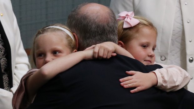 Treasurer Scott Morrison is hugged by his daughters, Lily and Abbey, after he gave the budget address on Tuesday.