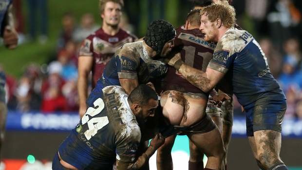 Full moon: Manly forward Anthony 'Choc' Watmough shows the Bulldogs defence some bare-faced cheek.