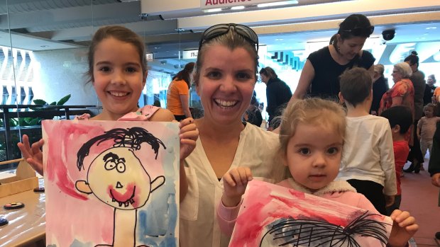 Stephanie Smith with her two daughters Izzy, 6, and Mia, 3, at the Out of the Box Festival in Brisbane on Tuesday.