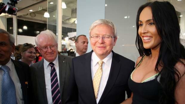 Kevin Rudd and the Labor candidate for Swan, John Bissett, smile as they met a voter in Westfield Carousel in Cannington in Perth on Friday.