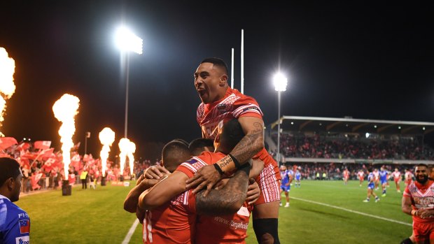 Big time: Tonga players celebrate on their way to an enthralling victory over Samoa.