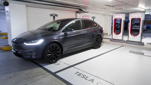 A Tesla vehicle recharges at Mirvac's Broadway shopping centre supercharge site.