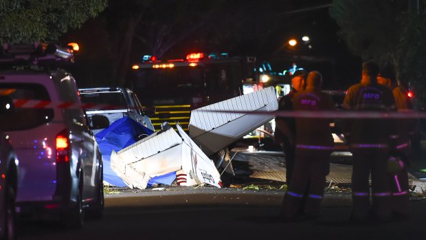 Police at the scene of the plane crash in Scarlet Street, Mordialloc, on Friday night.