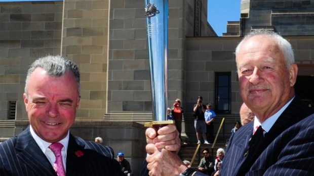 Dr Brendan Nelson, director of the Australian War Memorial and Alan Ferguson, chairman of Camp Gallipoli holding the RSL Anzac Flame that was presented to the Australian War Memorial in Canberra